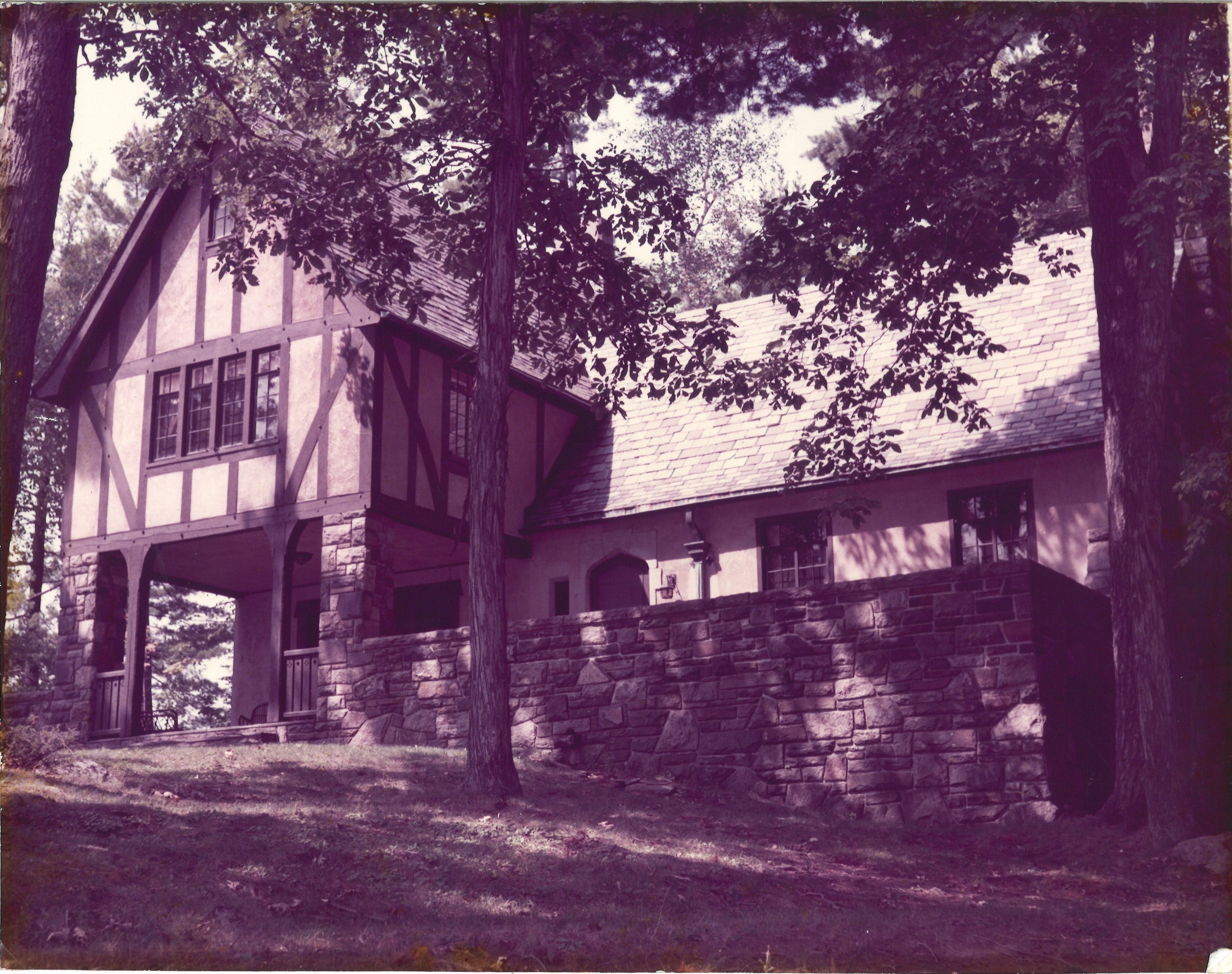 A picture of a house on Lake George that is faded and has not yet been restored.